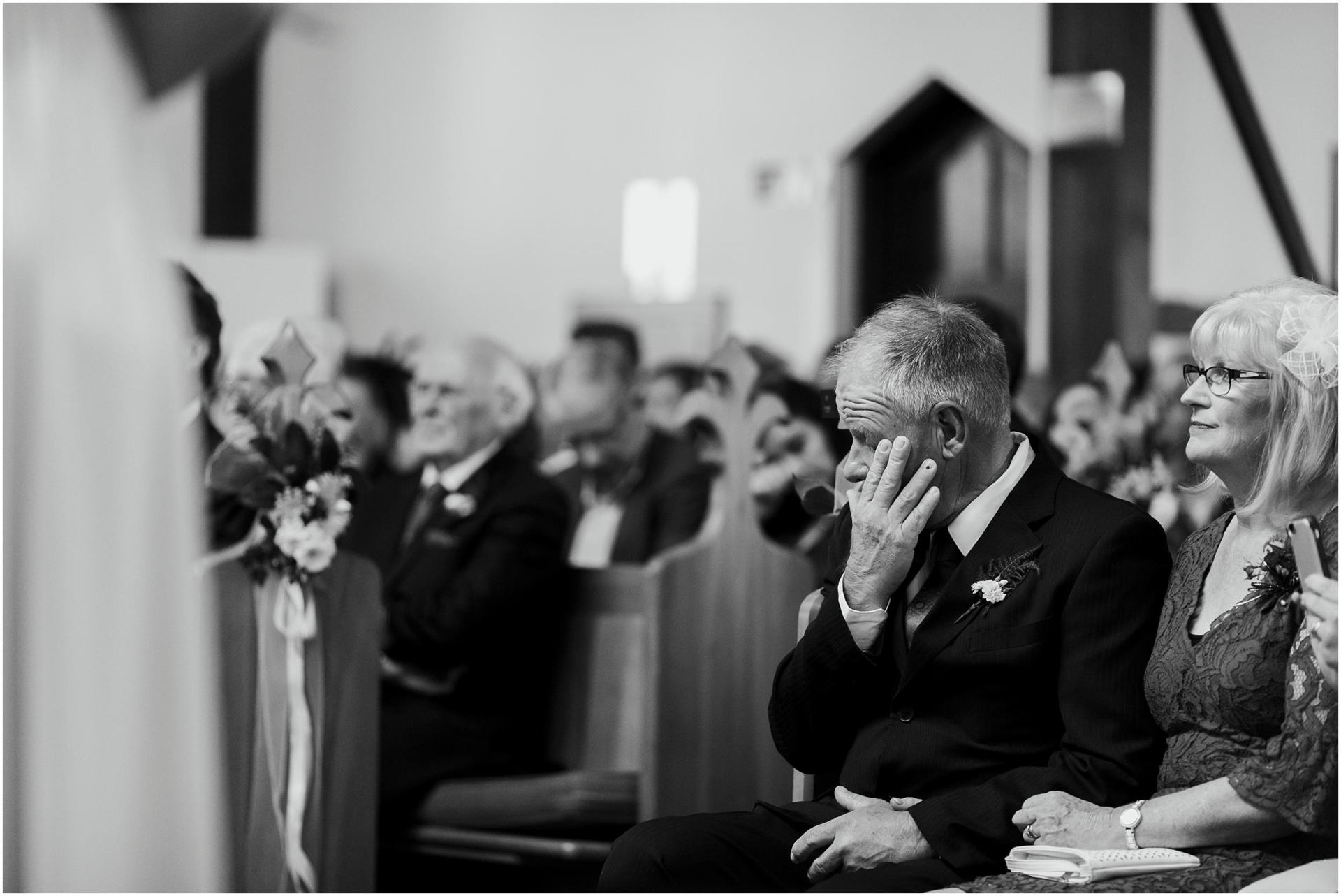 Charlotte Kiri Photography - Wedding Photography black and white photo of a member of the bridal party shedding a tear in the church at the wedding during the nuptials at Palmer Estate, Nelson.